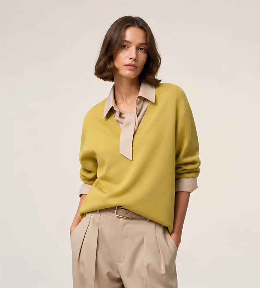 Model wearing the Knitted V-neck top over a beige shirt